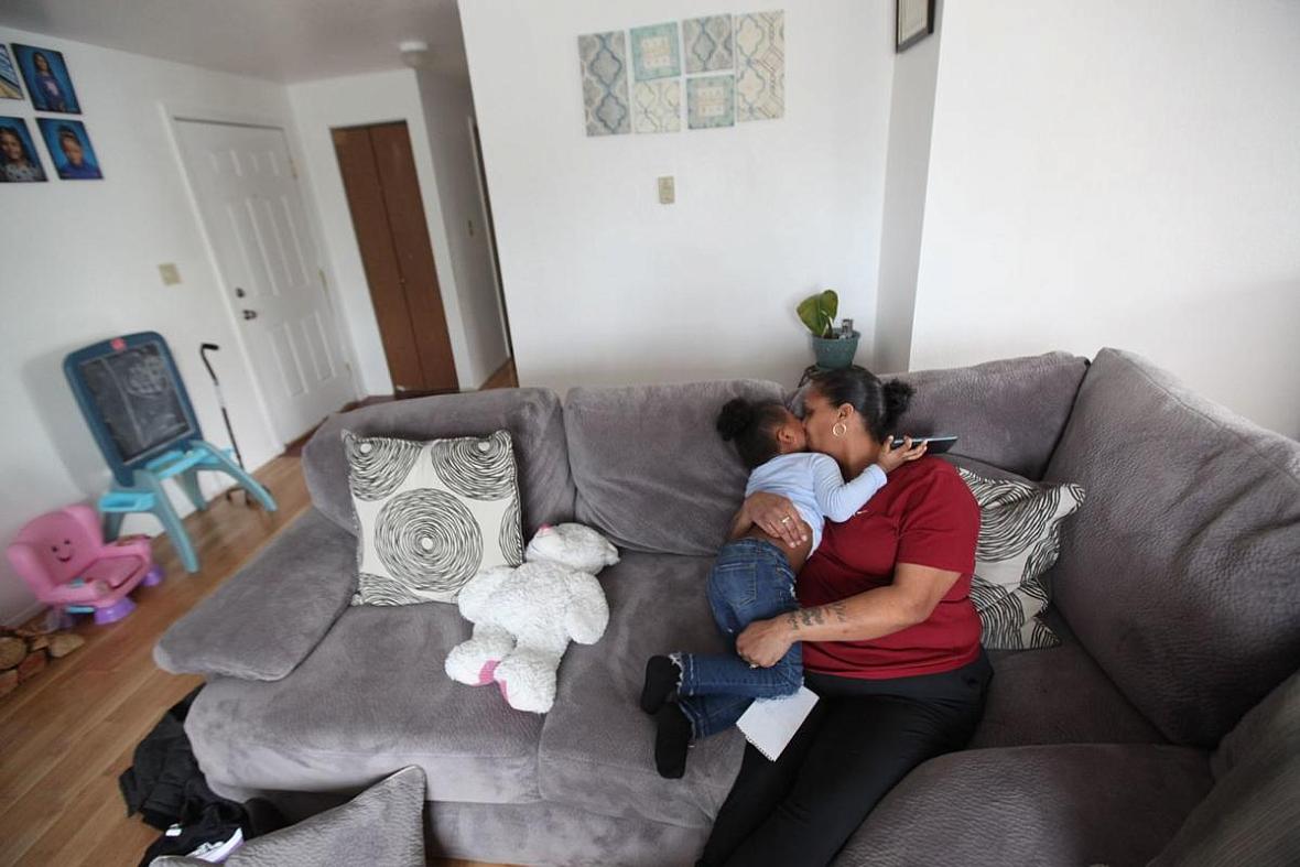 Kateri Whiteside embraces her daughter Nai'Yana Henderson at their apartment in Des Moines, Washington.