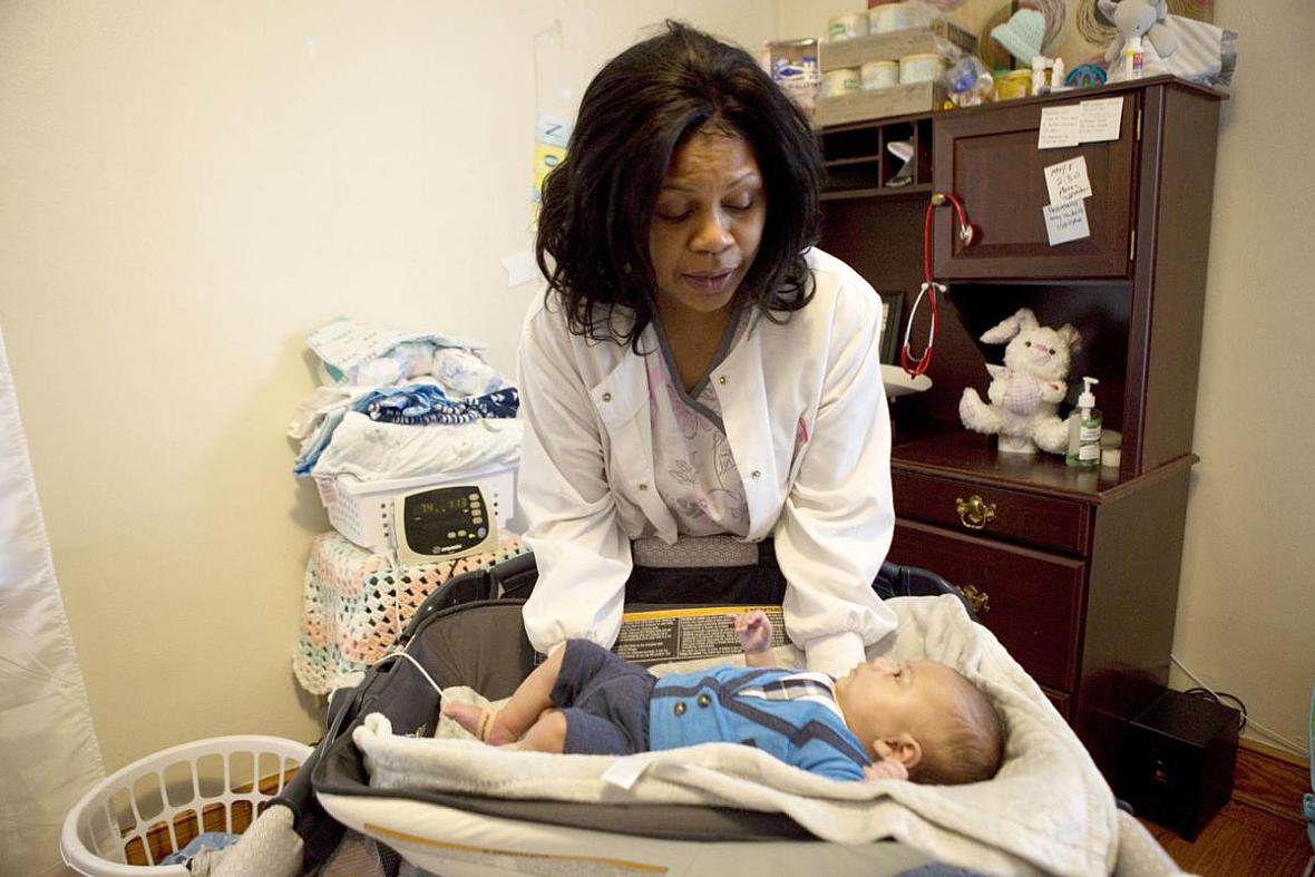 Flossie Horace takes oxygen levels and weighs her 3-month-old grandson every morning in her Roanoke home.