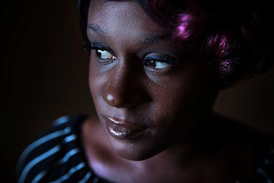 Ashley Peterson looks out of the single window in her motel room at Airway Motel in Atlanta, on Thursday, July 12, 2018. Ashley Peterson looks out of the single window in her motel room at Airway Motel in Atlanta, on Thursday, July 12, 2018.