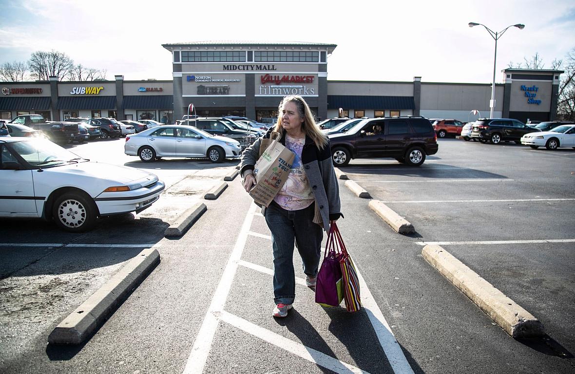 Michele Dutcher takes a bus to and from the Valumarket at the Mid City Mall on Bardstown Road a few times a week for groceries. 