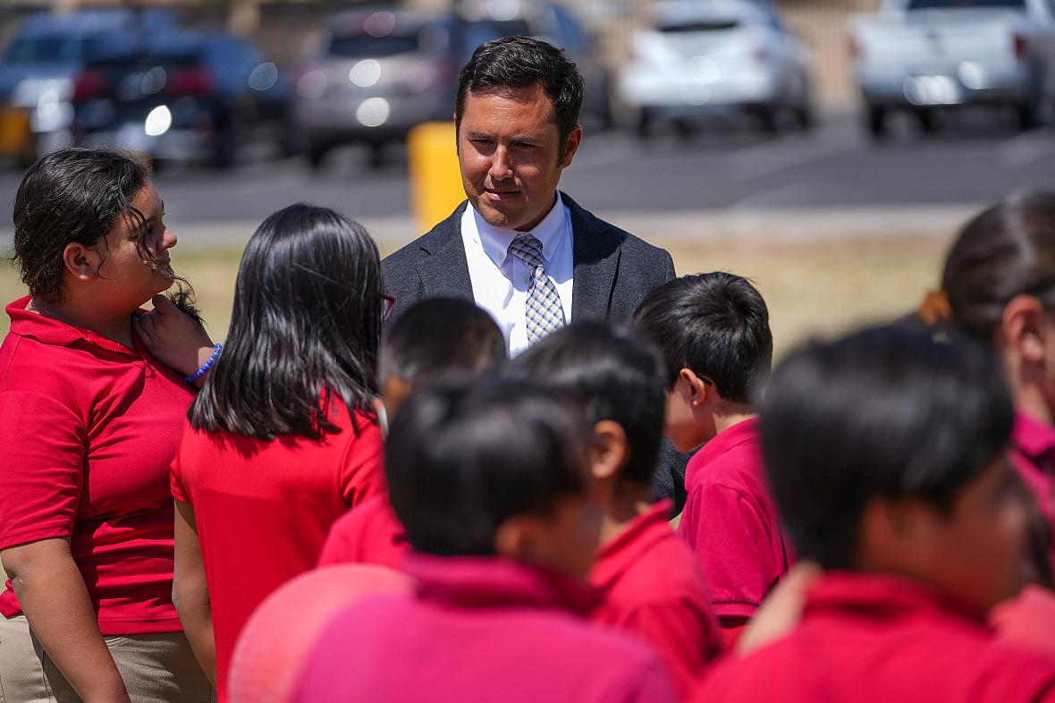 Tony Alcala, principal of Galveston Elementary School, listens to a group of fourth graders during recess at Galveston Elementar