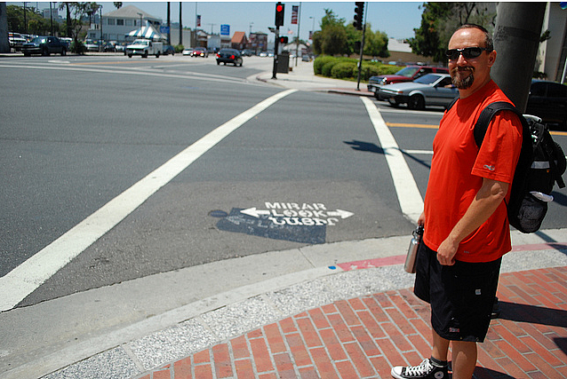 Glendale PLACE Grant Coordinator Colin Bogart shows off the new tri-lingual pedestrian safety markings at an intersection adjacent to Glendale City Hall. Glendale PLACE Grant Coordinator Colin Bogart shows off the new tri-lingual pedestrian safety markings at an intersection adjace