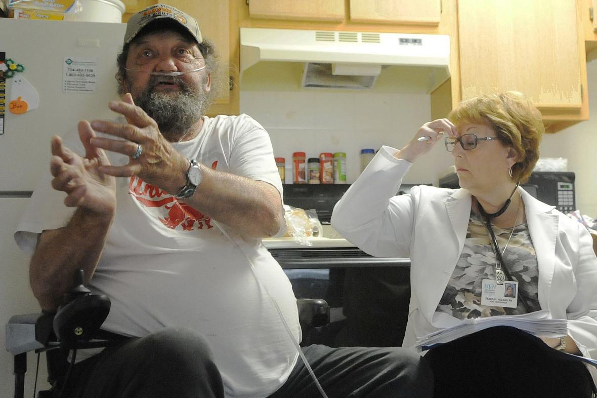 Clifford Schmidt, 71, talks with Monongahela Valley Hospital nurse Deborah Holman during a scheduled home visit in Mon Valley.