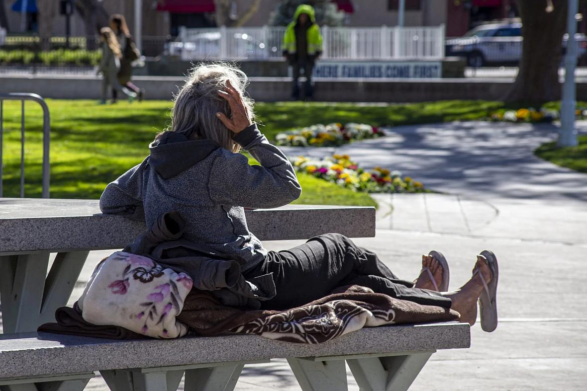 A homeless woman rests on a bench at Todos Santos Plaza in Concord, Calif., on Feb. 15, 2022. A homeless woman rests on a bench at Todos Santos Plaza in Concord, Calif., on Feb. 15, 2022.