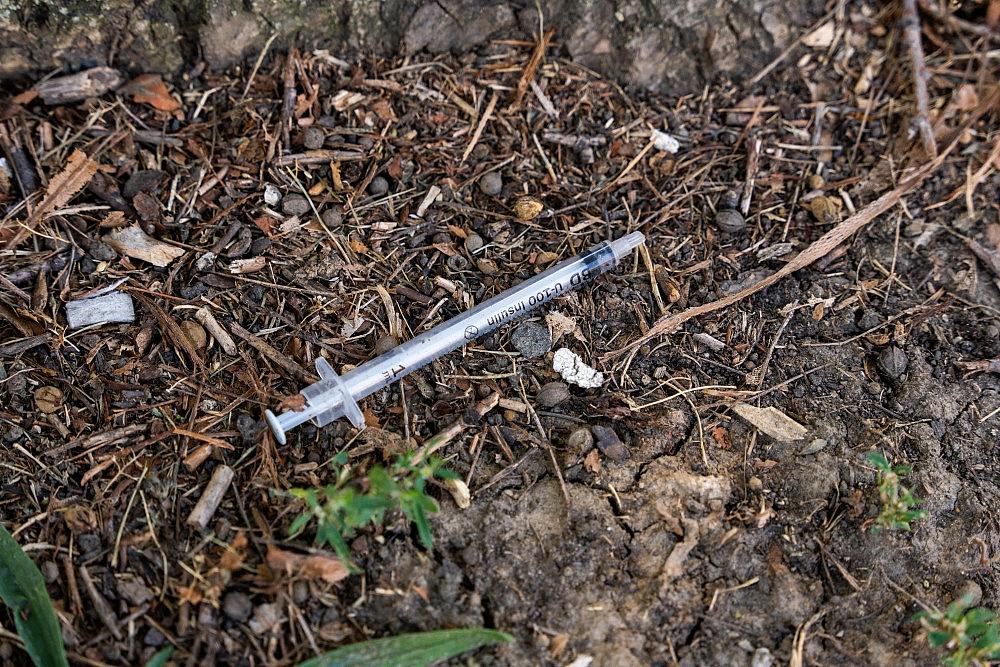 A used needle on the ground in Garfield Park in an area known for heroin use.