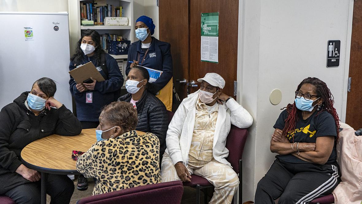 Community members listen to VCU Massey Cancer Center Director Robert Winn during his district walk in late March in Highland Spr