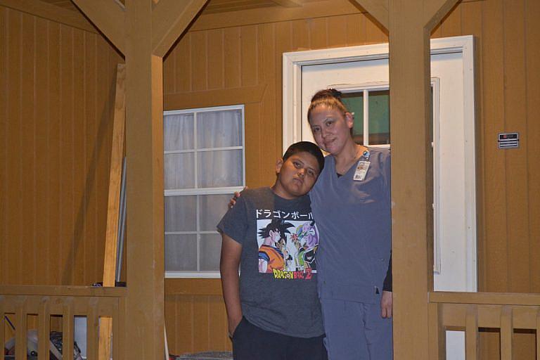 Chelsea and Ethan Holtsoi in front of their cabin near Many Farms on the Navajo Reservation.