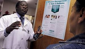 Dr. Kwabena Adubofour talks to Yolanda Reyes, 54, about diabetes and its health risks at the East Main Clinic & Stockton Diabete