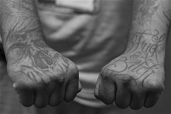 Tattoos — symbols of the struggle of his earlier years — warn you against crossing a former gang member. (Photo by Sahra Sulaiman/LA Streetsblog)