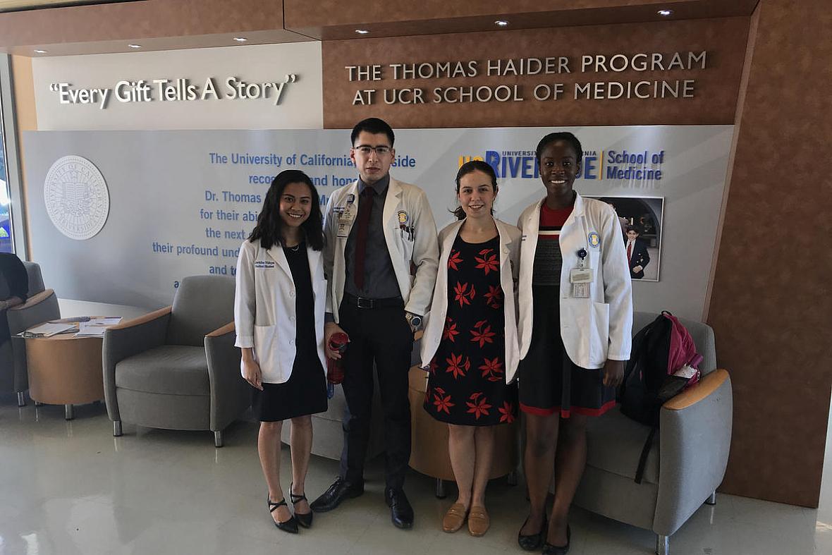 UCR medical students Jericha Viduya, Antonio Garcia, Monica Gutierrez, and Kleshie Baisie pose for a picture in their white coat
