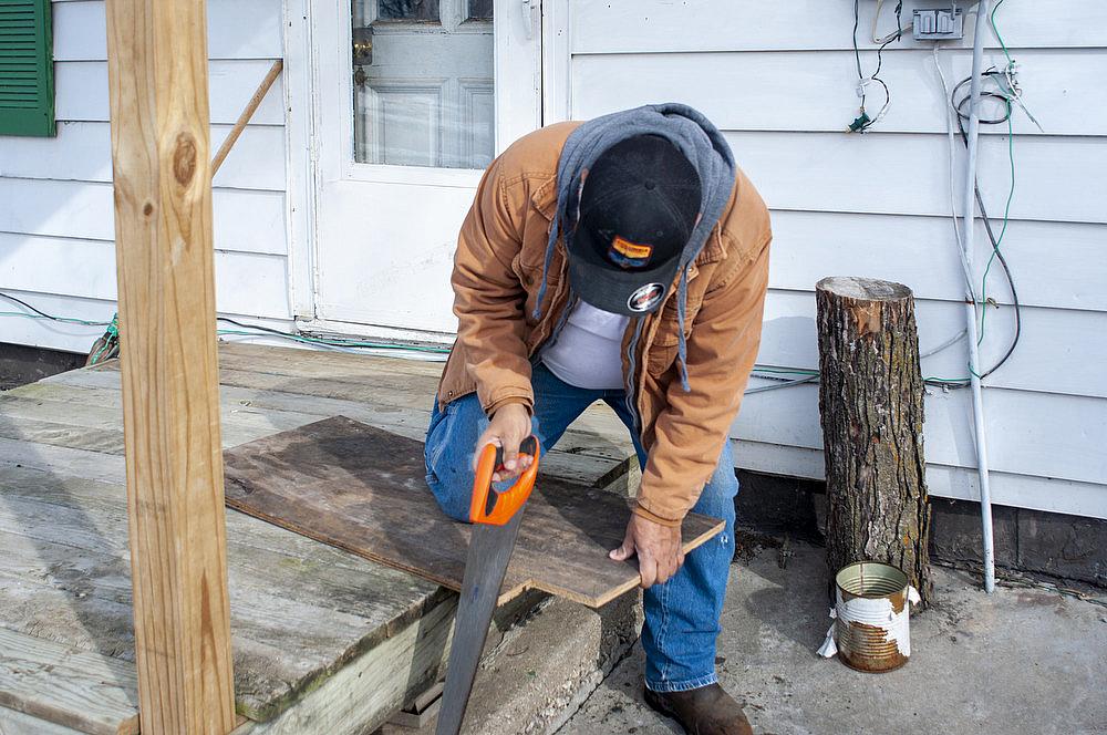 Luis, not his real name, cuts wood to repair a section of flooring in his Mt. Pleasant, Iowa home on Monday, February 3, 2020.
