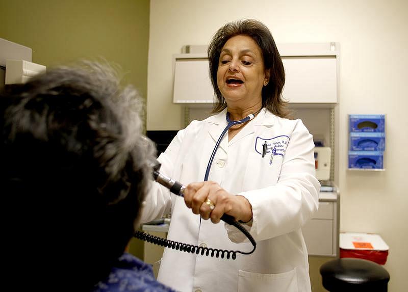 Dr. Elyzabat Tadros examines Elizabeth Torino at Kaiser Permanente medical offices.