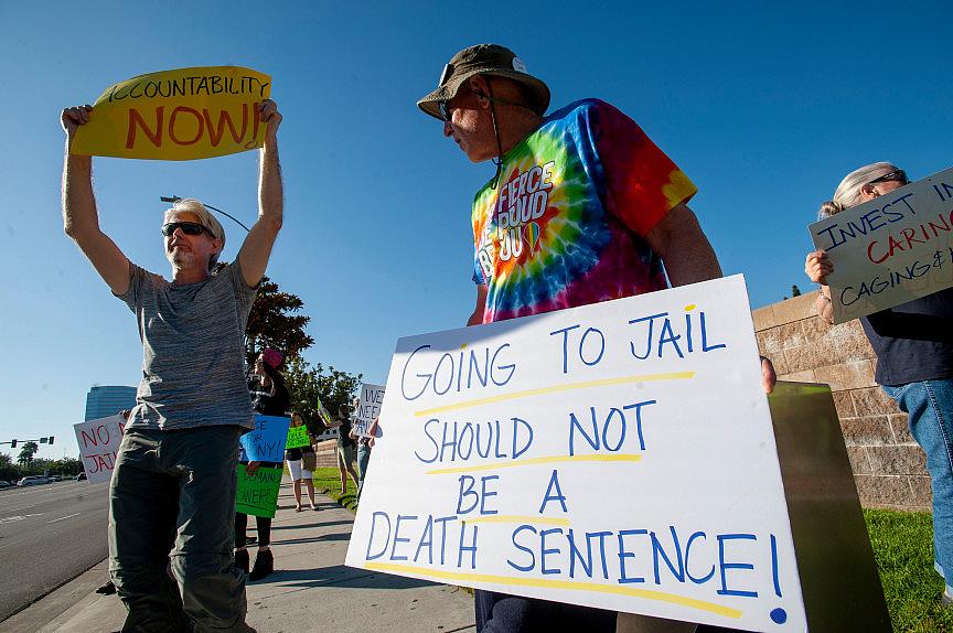 Andy Lewandowski, center, of Anaheim takes part in a rally outside the Theo Lacy Facility in Orange on Saturday, July 20, 2019 t