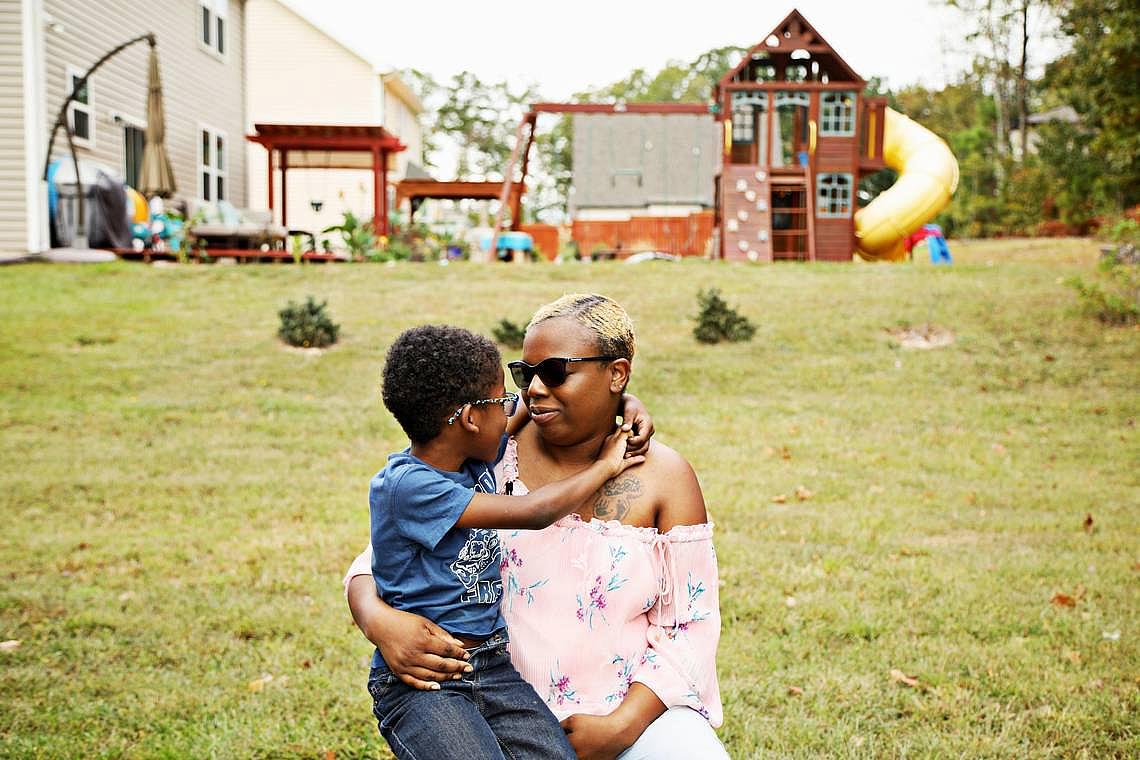 Laura Miles holds her oldest living son, Dasan, 7, in the family’s Durham backyard Oct. 5, 2019. Miles first child, Kingston, was born at 23 weeks with underdeveloped lungs and died in a day. (Photo by July Leonard/News&Observer)