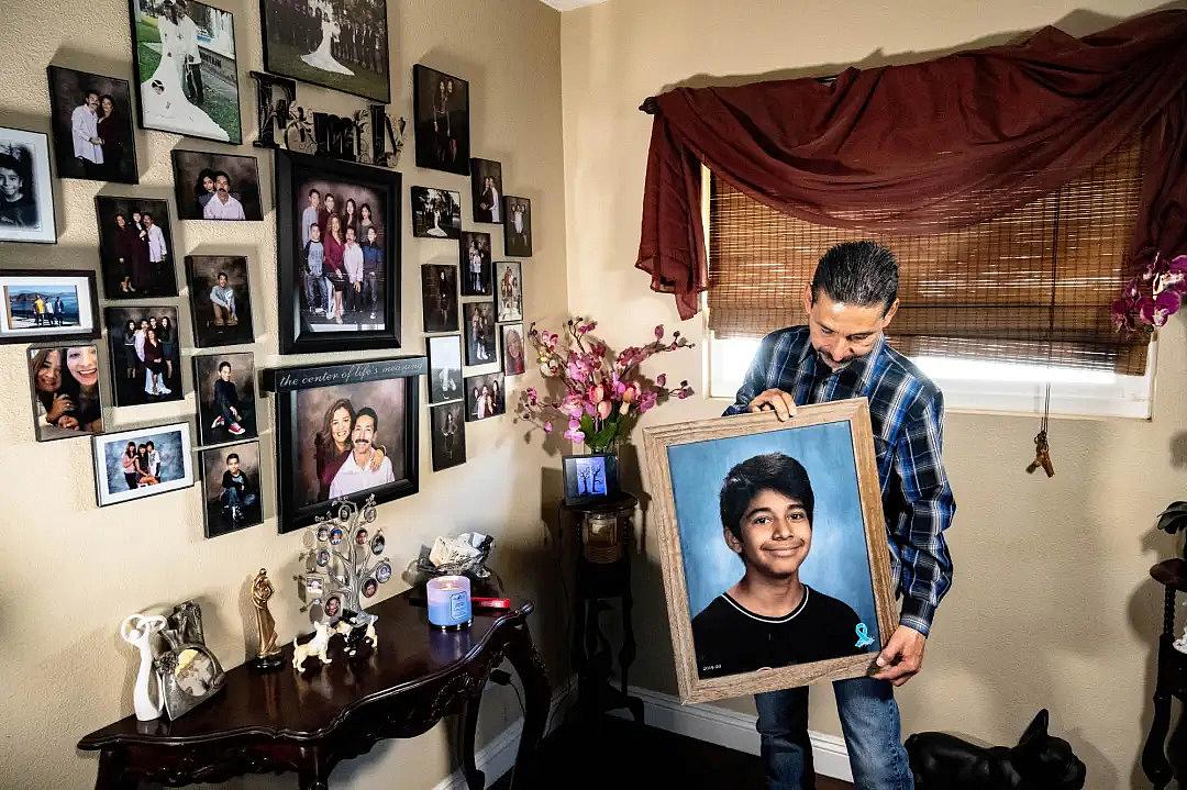 Felipe Salcedo holds a framed picture of his late nephew, Diego Stolz, at his Moreno Valley home Wednesday, March 23, 2022. The 