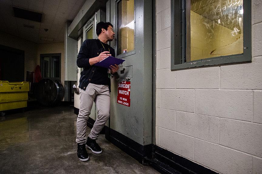 Clinician Marvin Rodriguez checks on an inmate in a suicide-watch cell at West Valley Detention Center in Rancho Cucamonga on Fr