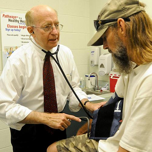 Dr. Michael Lewis, secretary of the state Department of Health and Human Resources, volunteers at the West Virginia Health Right