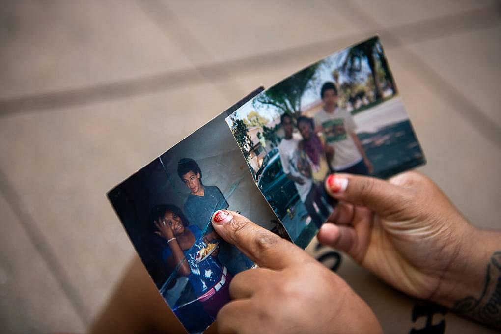 Iyana Spruell points to her cousin Sterling Ulrich in a photo of them as teens in Merced, outside her home in San Francisco's Te