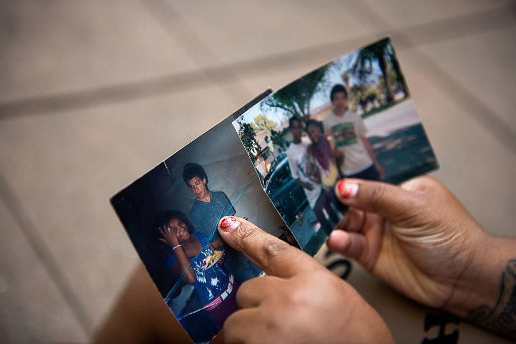 Iyana Spruell points to her cousin Sterling Ulrich in a photo of them as teens in Merced, outside her home in San Francisco's Tenderloin neighborhood, March 14, 2022. Spruell had reconnected with Ulrich last summer, only months before Ulrich died of an overdose at the Hotel Whitcomb in November. Iyana Spruell points to her cousin Sterling Ulrich in a photo of them as teens in Merced, outside her home in San Francisco's Te