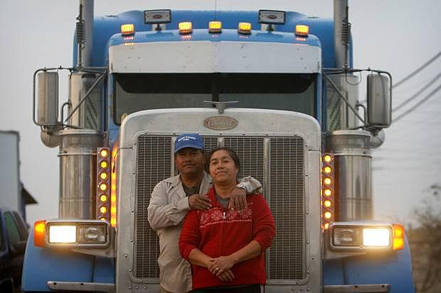 Jose Rodriguez and his wife, Maria, with their truck near their home in Jurupa Valley. The family makes a living moving goods around the nation. Photo Credit: STAN LIM/STAFF PHOTOGRAPHER Jose Rodriguez and his wife, Maria, with their truck near their home in Jurupa Valley. The family makes a living moving goods around the nation.