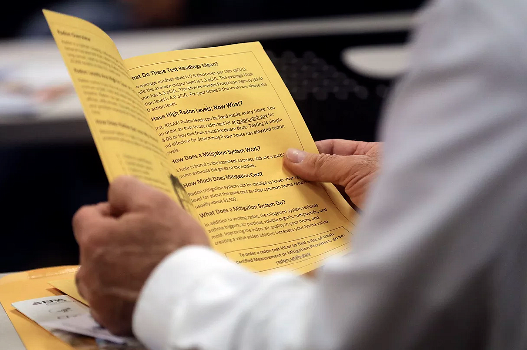 Wayne Corbridge, Sego Homes owner, reads about radon during a continuing education class called Radon.