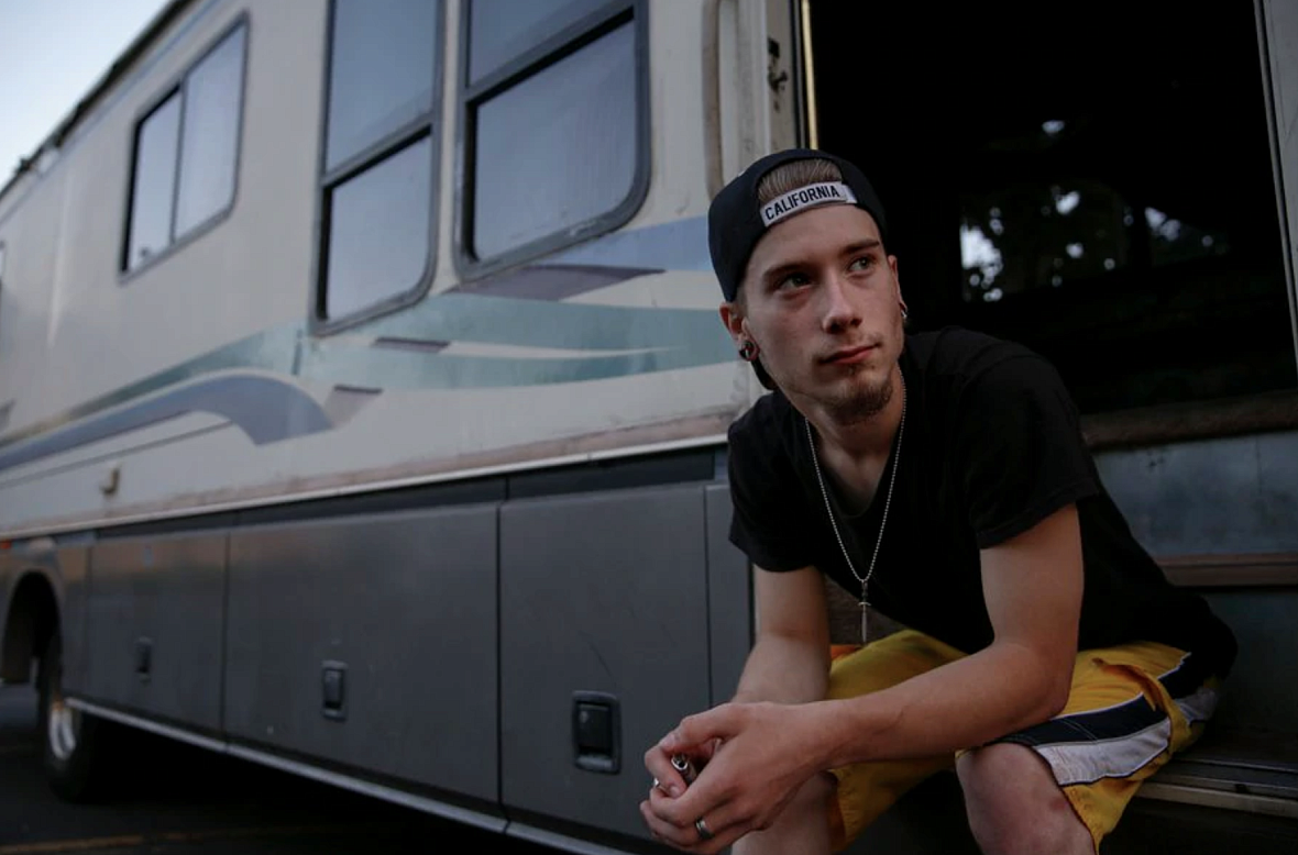  Caleb La Chance, 18, sits on the steps of the RV he lives in for a portrait on Tuesd