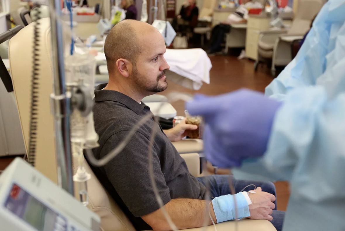 Dustin Wallis, a 39-year-old nonsmoker, receives an infusion to treat stage 4 lung cancer at Utah Cancer Specialists in South Sa