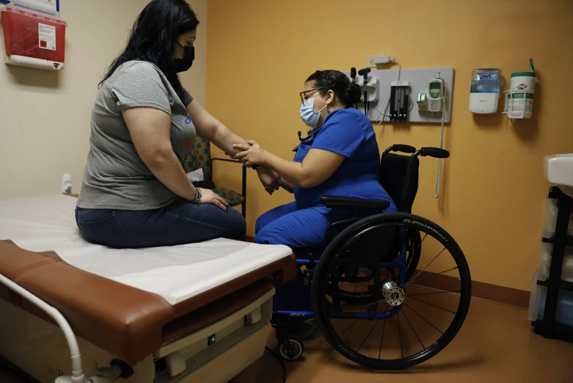 Dr. Marie Flores examines patient Karla Olguin, 35, at the AltaMed clinic in Pico Rivera.