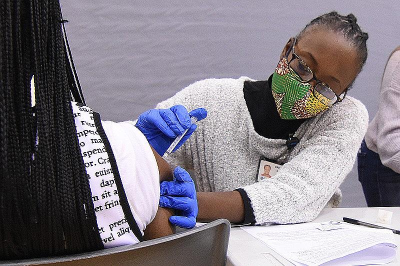 Creshelle Nash, the medical director for health equity and public programs at Arkansas Blue Cross and Blue Shield, administers a dose of the coronavirus vaccine at Jack Stephens Arena on the University of Arkansas at Little Rock campus in this Nov. 21, 2021, file photo. Nash says that addressing structural racism would go a long way to improving health outcomes in the Arkansas Delta. Creshelle Nash, the medical director for health equity and public programs at Arkansas Blue Cross and Blue Shield, administers a