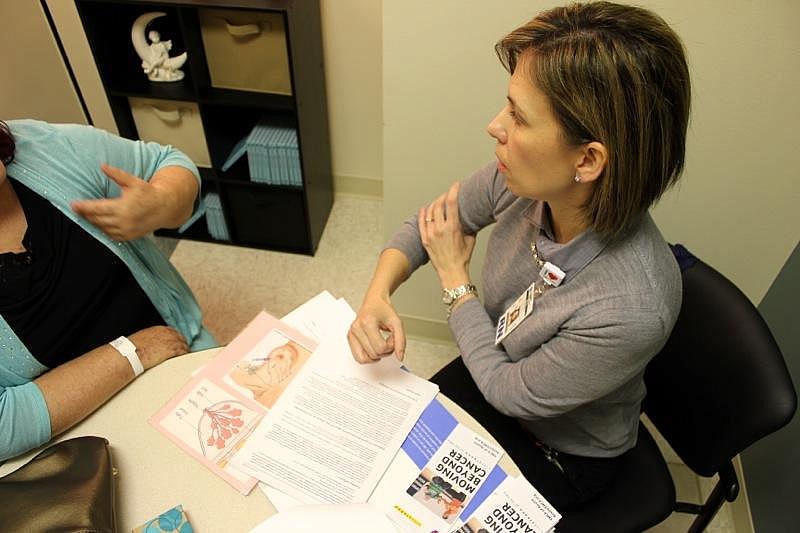 Seton Survivorship Nurse Navigator Veronica Serrano, right, helps a purposely unidentified former cancer patient on Nov. 19, 2014. Veronica Zaragovia/KUT