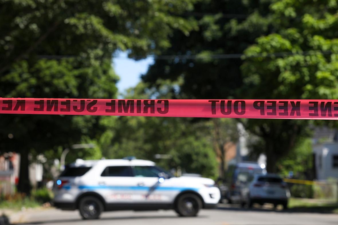 Police tape marks off a Chicago street as officers investigate the scene of a fatal shooting in the city's South Side on Tuesday