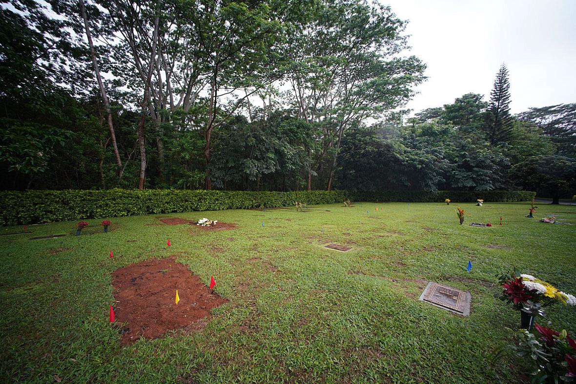 Fresh earth covers the grave of Neita Bolkeim at Hawaiian Memorial Park in Kaneohe.