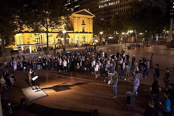 Members of recovery programs, graduates and supporters listen as Patty Katz discusses her battle during an event celebrating recovery in Pioneer Courthouse Square in Portland, Ore. Alton Strupp/the Courier-Journal