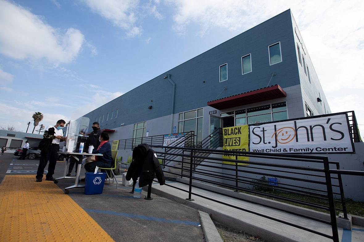 Patients arrive at the St. John's Well Child And Family Center to get inoculated with the Pfizer COVID-19 vaccine in South LA