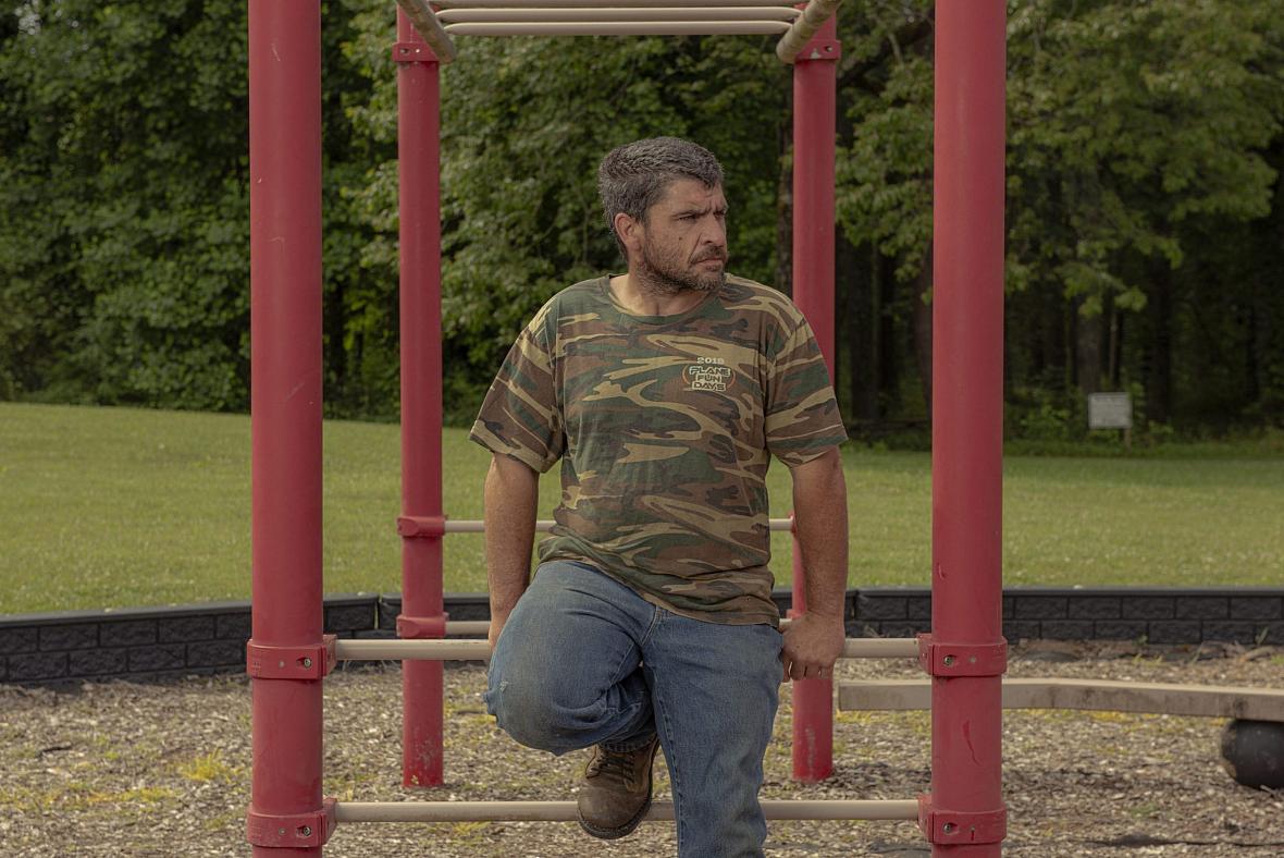 Brian Hogan sits outside a school in Marble on Saturday. 