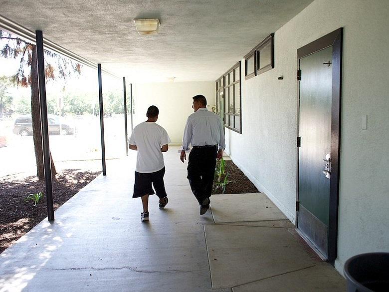 Teacher and student walk down hallway