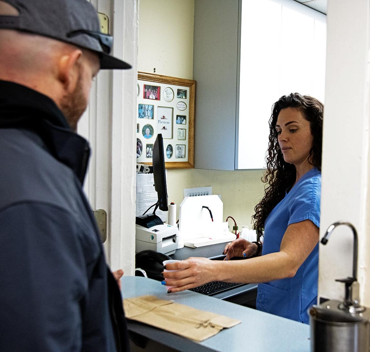 A client receives his dose of methadone from a dispensing nurse at C.O.R.E. Medical Clinic in Sacramento, California, on March.