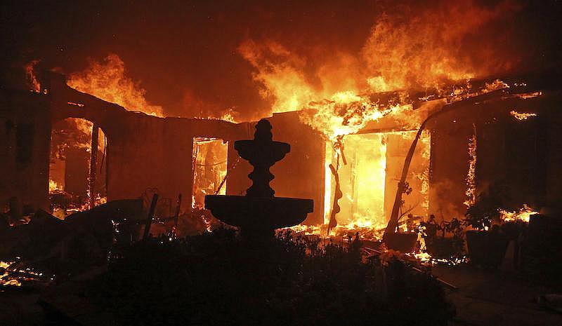 A home is consumed by the Woolsey Fire in Malibu, Calif., on Friday, Nov. 9, 2018.