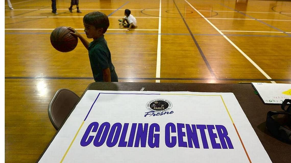 Kids play basketball at Ted C. Wills Center, on 770 N San Pablo Ave, Fresno which is one the four cooling centers in the city of