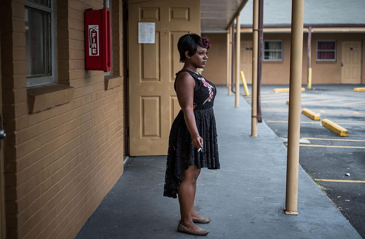 Ashley Peterson smokes a cigarette just outside of her Airway Motel room in Atlanta.