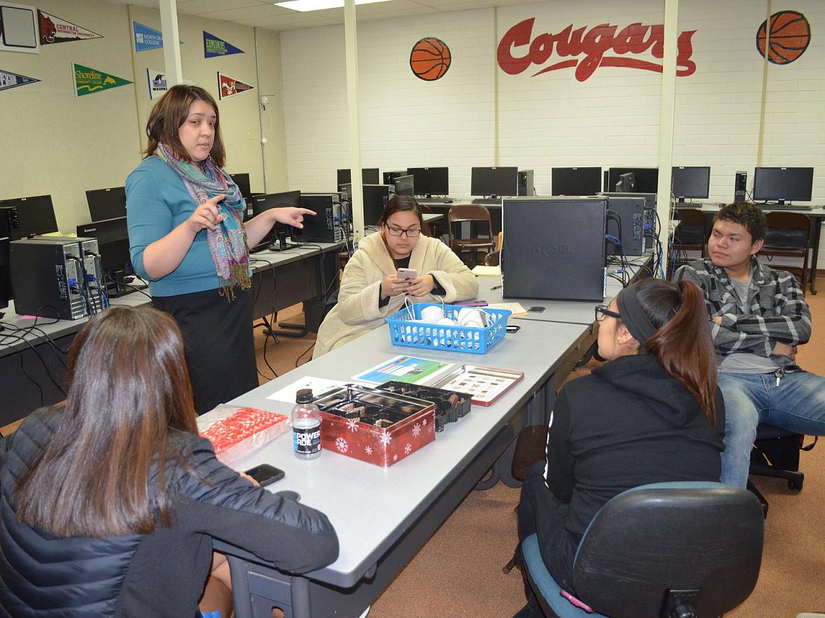 Karolynn Tom, who works with Jessica Black at Heritage University, is teaching students how to set up air quality monitors.