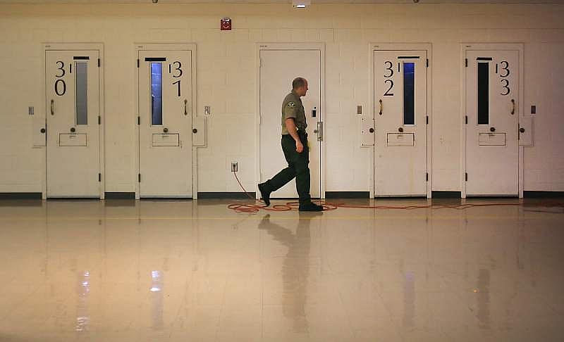A Sonoma County sheriff corrections officer makes his rounds in the mental health wing at the Sonoma County Main Adult Detention