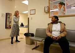 Nurse/midwife Leah Staples checks in with patient Ebony Carpenter about her blood pressure at the Gary Community Health Center i