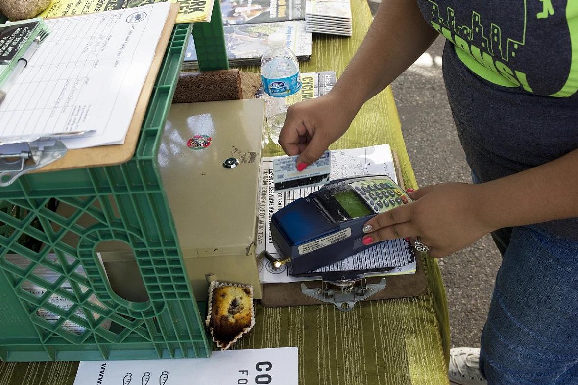 A customer swipes an EBT card at a farmers' market in New York City. Andrew Lichtenstein / Corbis via Getty Images file
