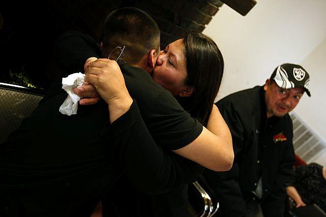 Jordan Torres, 15, hugs his mom, Tina Torres, at his graduation from Sea Mar's Renacer Youth Treatment Center in Seattle. At rig