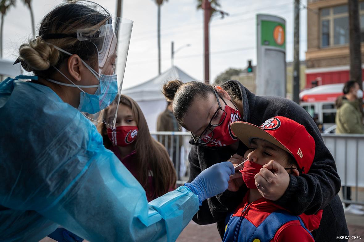 A technician swabs a little boy.