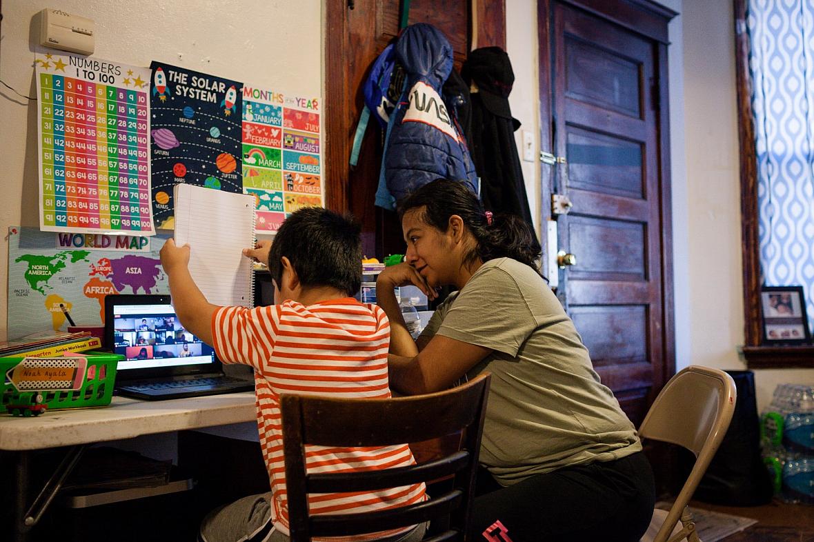 Serai Camarillo supports her son Noah Ayala, 6, as he learns remotely from their Little Village home during the pandemic on Nov.