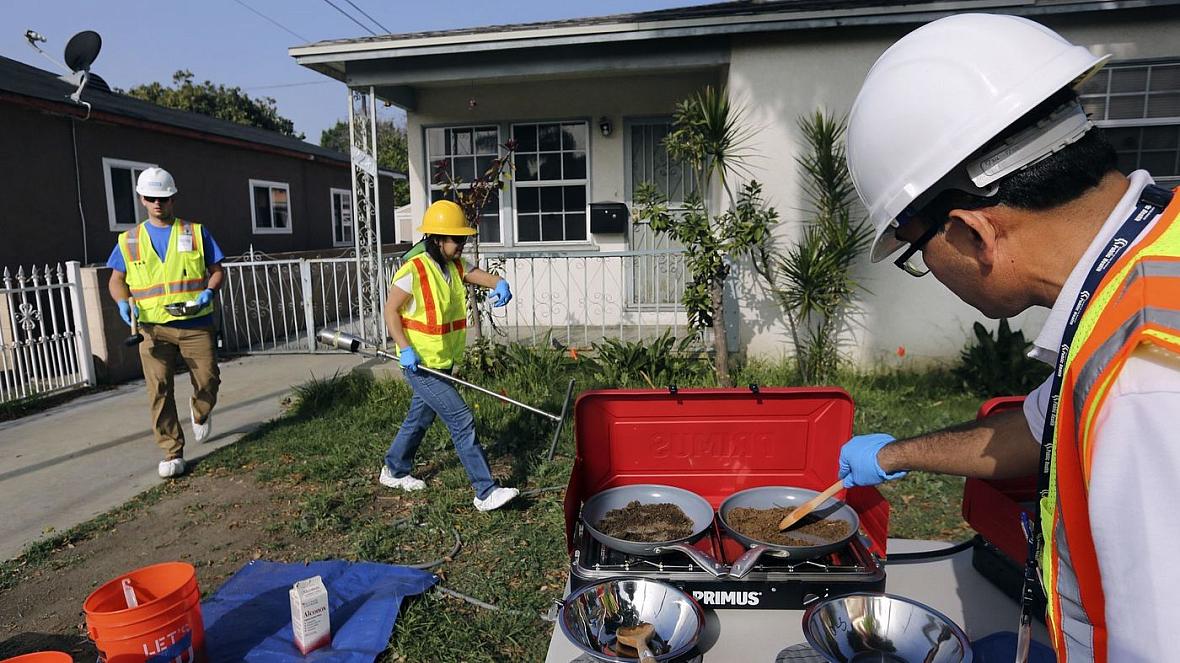 Bharat Dungrani, an environmental health specialist for the L.A. County Health Dept, removes moisture from soil samples collecte