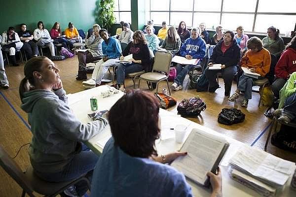 Women residents of Louisville's The Healing Place discuss using the 12 steps to combat their addictions during a class held at Saint Stephen Church. Dec. 6, 2012