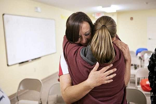 Cumberland Hope Community residents Tameka Napier, right, and Lauren Radzimirski console each other after Radzimirski was questioned by peers to gain a better understanding of her strengths and areas to improve.